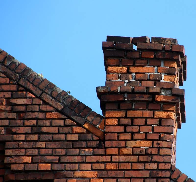 Signs Your White Marsh Home Needs a Chimney Inspection Damaged chimney on an White Marsh home showing cracks and missing mortar